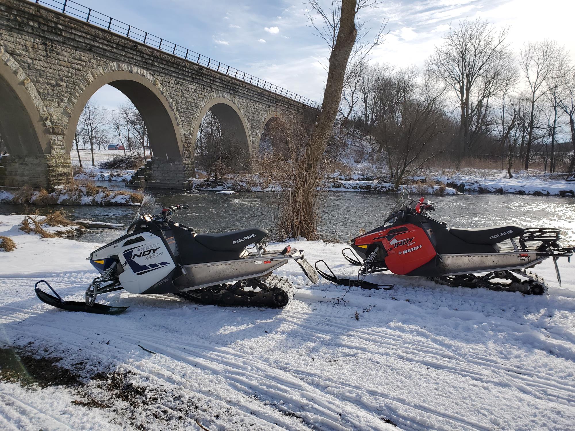 Snowmobiles Near River
